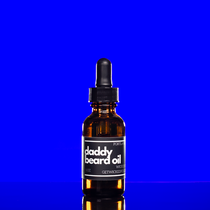 Wicked Fox's Daddy Beard Oil in a sleek bottle. Perfect for gay men seeking quality beard care online. Infused with a seductive leather scent, it's a favorite in the BDSM community. This beard oil not only reduces ingrown hairs but also imparts a sexy smell for irresistible facial hair.
