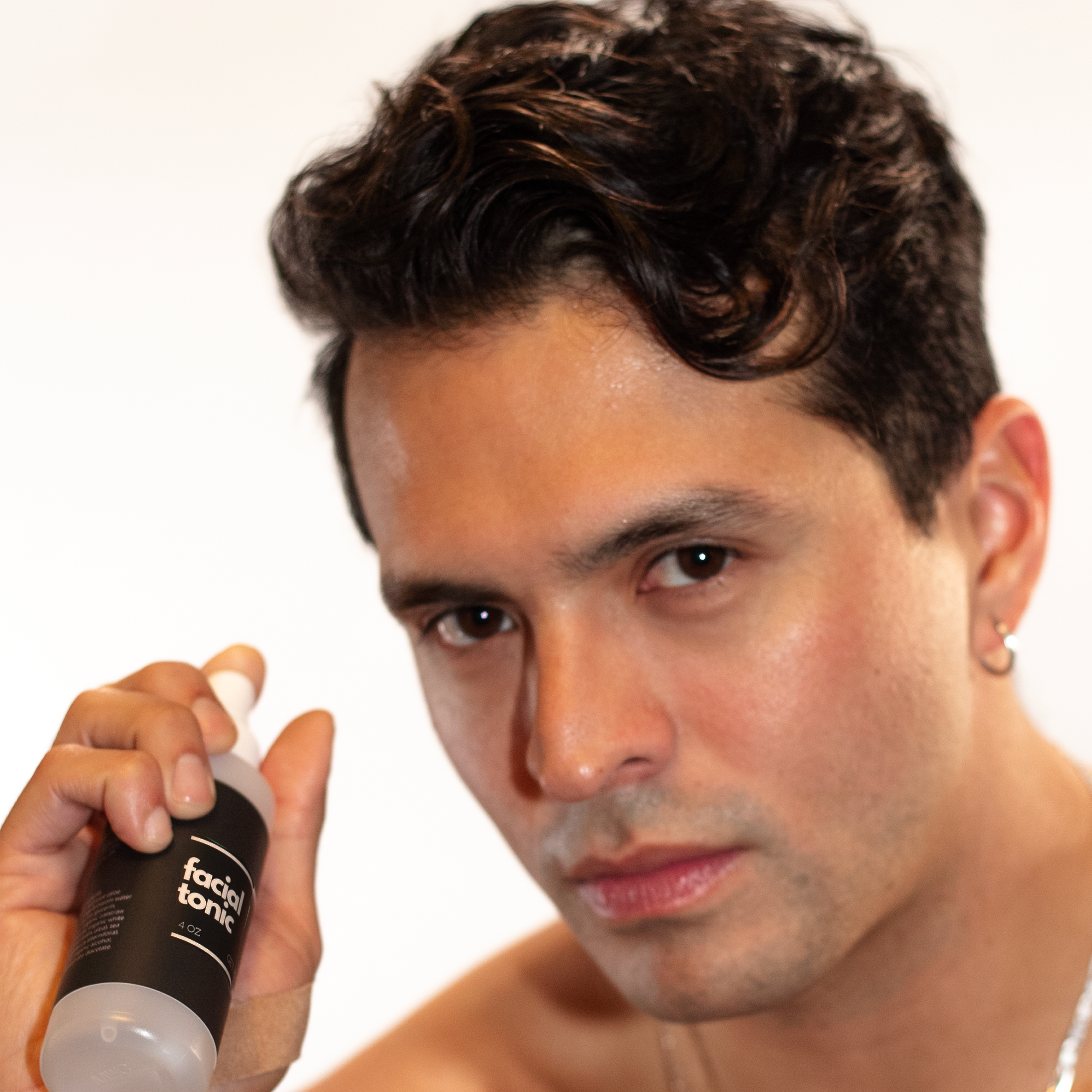 Close-up image of Wicked Fox's Facial Tonic, a skincare spray made in Portland. The bottle has a sleek design with the brand's distinctive fox logo. Ideal for gay queer men seeking to enhance their natural glow and rejuvenate their skin.