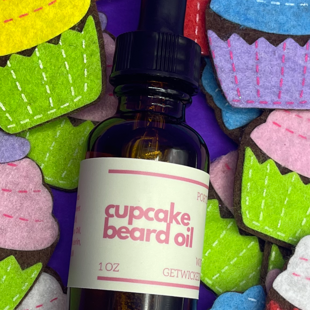 A bottle of Wicked Fox's Cupcake Beard Oil, enriched with natural ingredients, designed for the grooming needs of queer and trans men. Perfect for softening facial hair and reducing skin blemishes. Ideal beard care product for gay men shopping online.