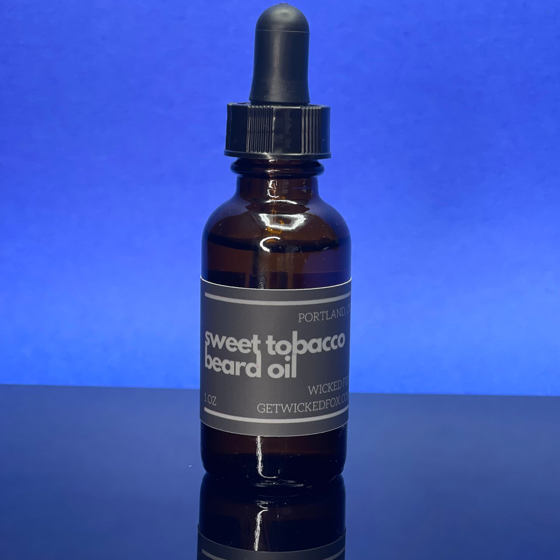 Wicked Fox's Sweet Tobacco Beard Oil, a premium beard care product targeted at gay men. This luxurious oil is infused with a sweet, masculine scent, designed to soften facial hair and prevent ingrown hairs. Making you more kissable, this must-have grooming accessory is perfect for those seeking a softer, more manageable beard.