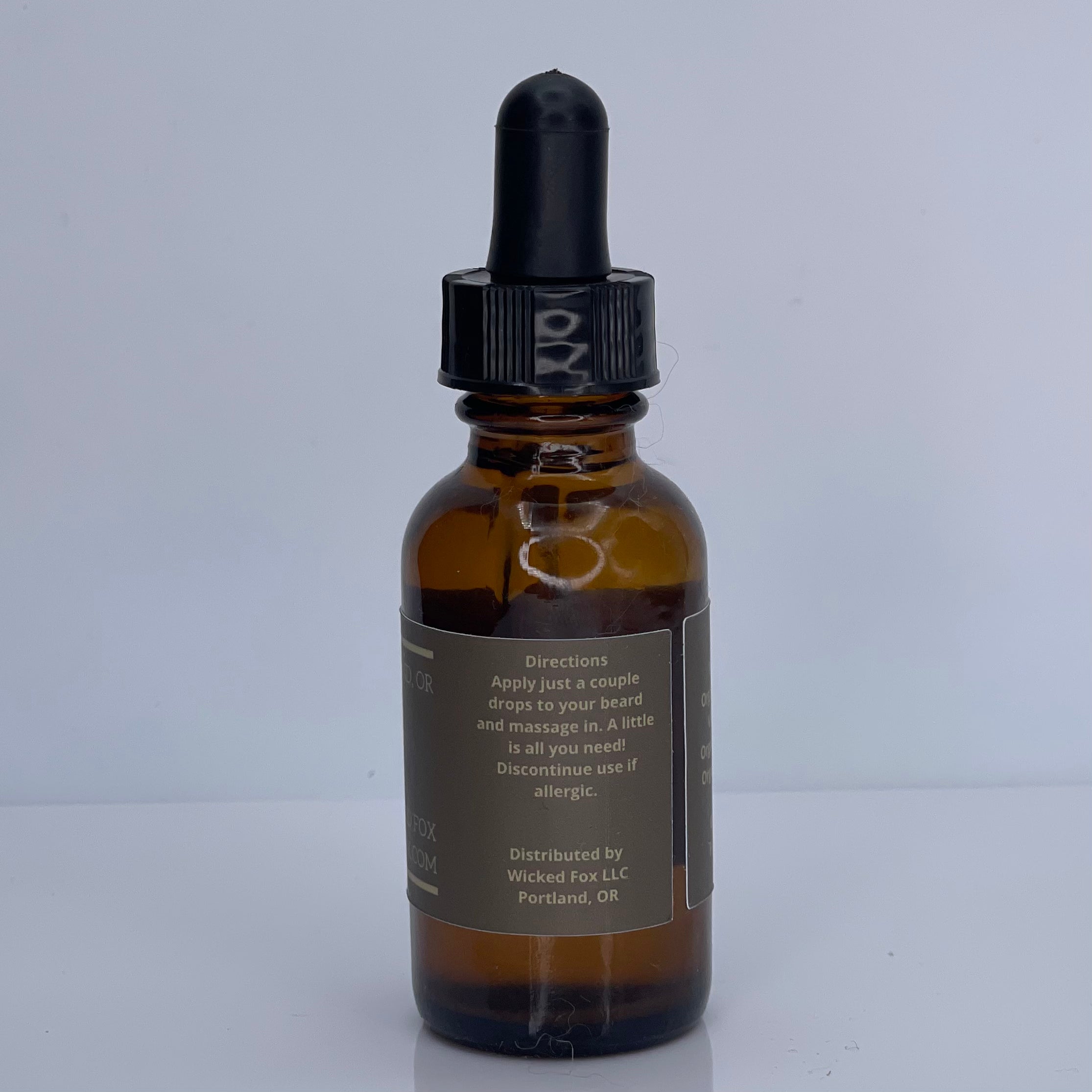 Wicked Fox's Gingerbread Beard Oil in a sleek bottle, ideal for gay men. This premium beard product reduces ingrown hairs, softens facial hair, and features an irresistible gingerbread scent, making you more kissable. Perfect choice for men looking to enhance their beard care routine with a sweet twist.