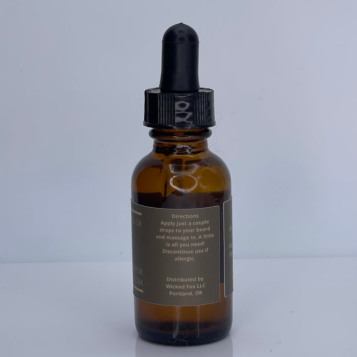 Wicked Fox's Gingerbread Beard Oil in a sleek bottle, ideal for gay men. This premium beard product reduces ingrown hairs, softens facial hair, and features an irresistible gingerbread scent, making you more kissable. Perfect choice for men looking to enhance their beard care routine with a sweet twist.