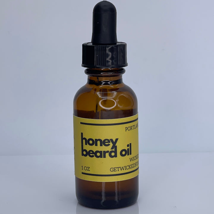 Wicked Fox's Honey Beard Oil in a sleek bottle, perfect for gay men seeking beard care products. Gingerbread-scented oil that softens facial hair, reduces ingrown hairs, and enhances kissability.