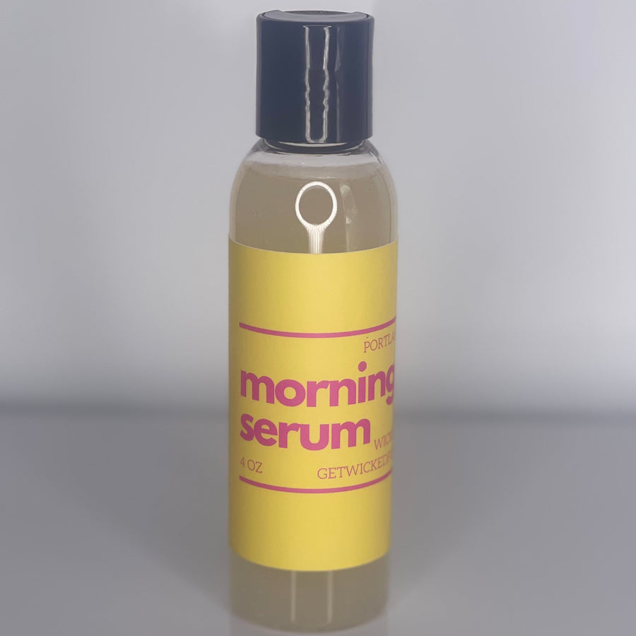 A sleek bottle of Morning Serum highlighted against a soft, radiant background. The serum is a clear, glowing liquid promising youthful and refreshed skin with key ingredients like Hyaluronic Acid, hyssop, and coffee extract.