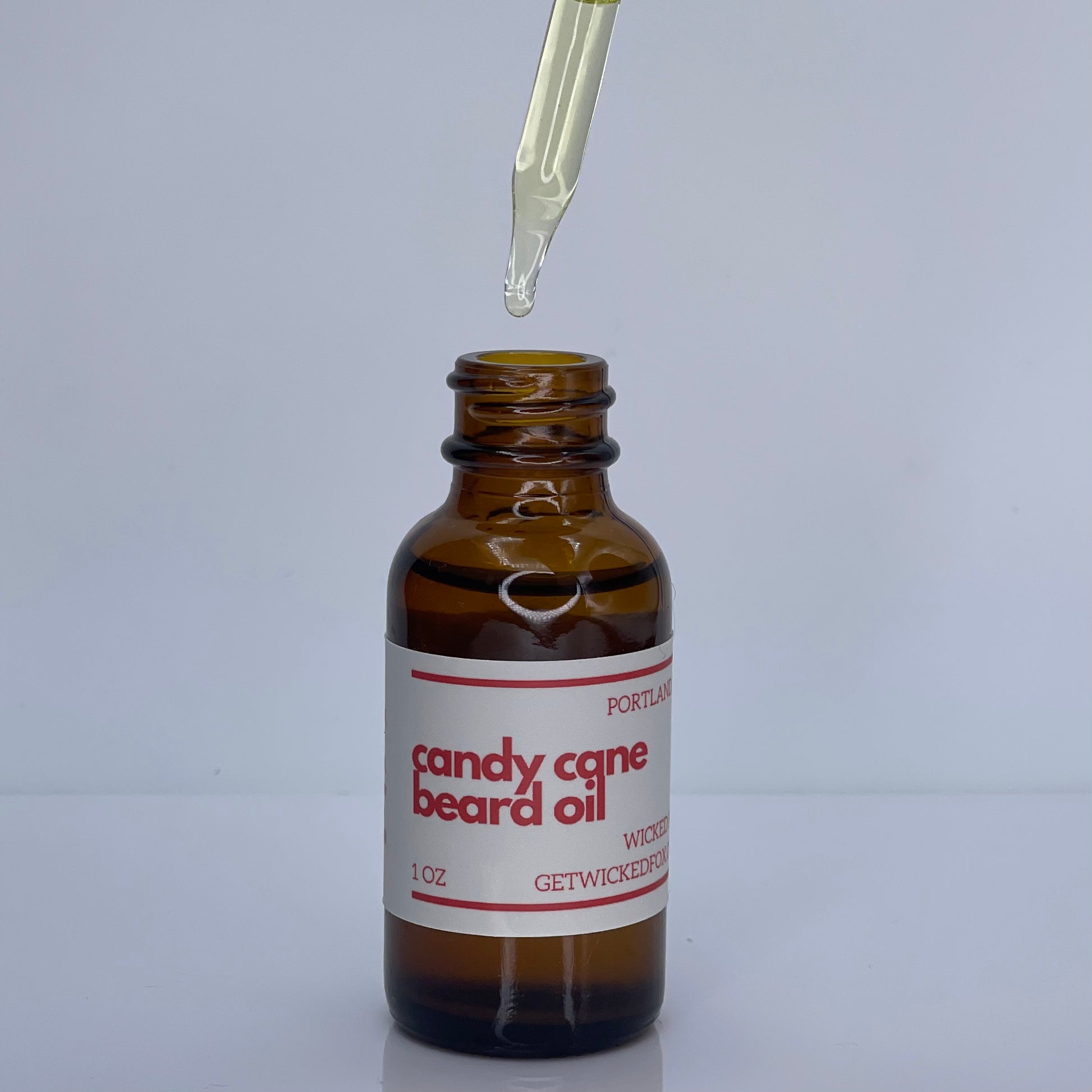 Discover Wicked Fox's Candy Cane Beard Oil - the ultimate grooming solution for gay men seeking soft and kissable beards. Elevate your grooming routine with this nourishing and invigorating blend, perfect for a refreshed and confident look.