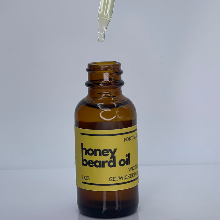 Wicked Fox's Honey Beard Oil in a sleek bottle, perfect for gay men seeking beard care products. Gingerbread-scented oil that softens facial hair, reduces ingrown hairs, and enhances kissability.