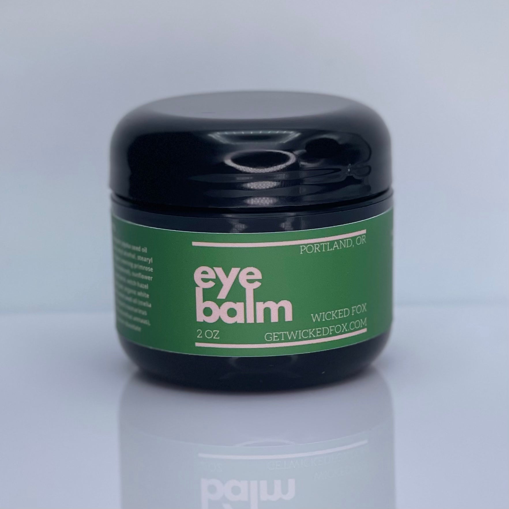 Image of Wicked Fox Eye Balm, an organic skincare product in a stylish, sleek container, specifically formulated for gay men seeking natural and effective solutions for reducing under-eye puffiness and preventing wrinkles.