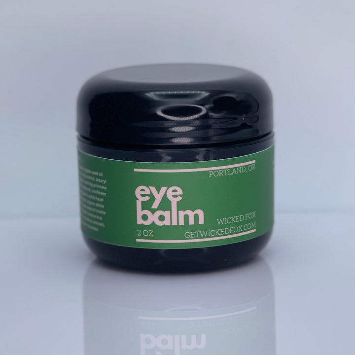 Image of Wicked Fox Eye Balm, an organic skincare product in a stylish, sleek container, specifically formulated for gay men seeking natural and effective solutions for reducing under-eye puffiness and preventing wrinkles.