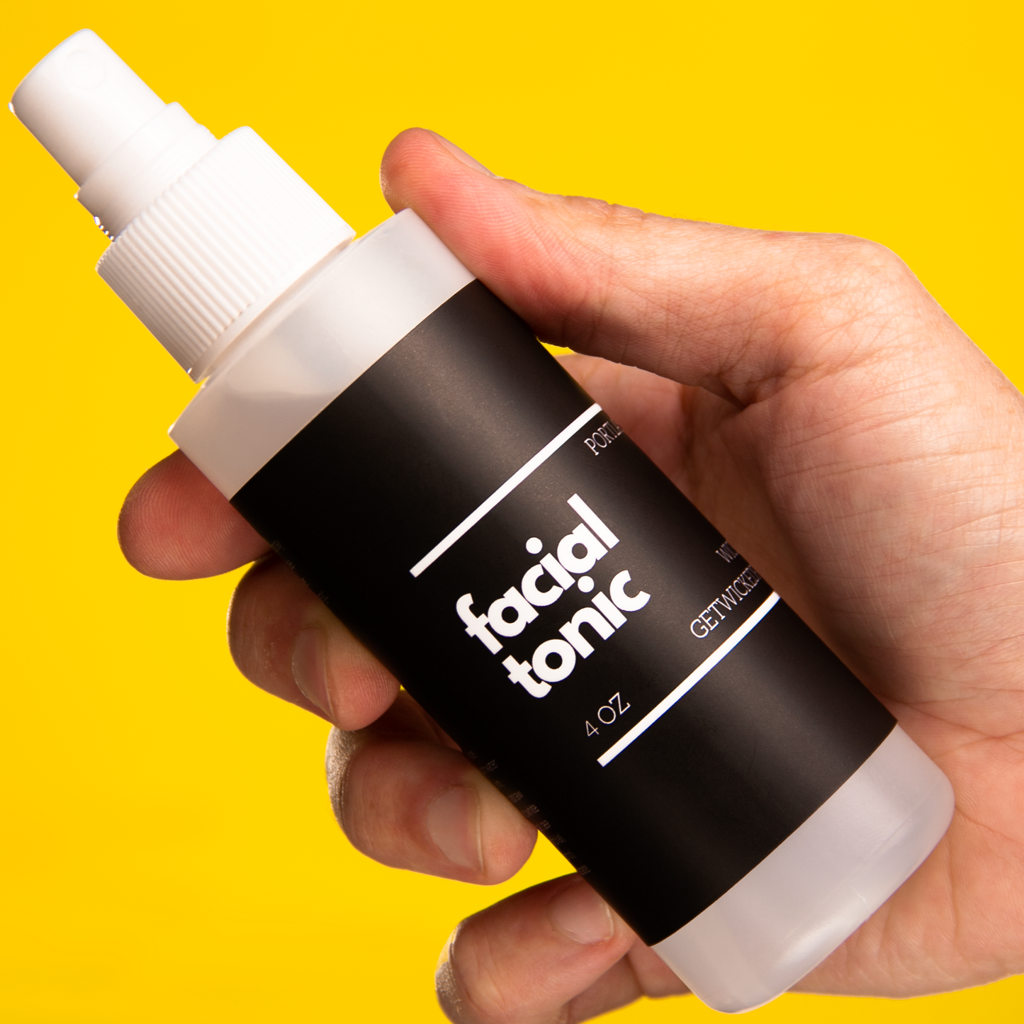 Close-up image of Wicked Fox's Facial Tonic, a skincare spray made in Portland. The bottle has a sleek design with the brand's distinctive fox logo. Ideal for gay queer men seeking to enhance their natural glow and rejuvenate their skin.